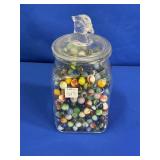 GLASS FALCON TOPPED JAR WITH MARBLES