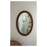 Two oval wall hanging mirrors
