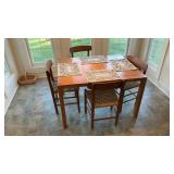 Wood dining table with four chairs and placemats