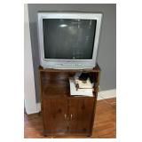 RCA TV with wooden TV stand and contents