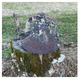 Metal dinner bell on stump