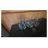 4 green stem glass wine glassses and 3 flutes