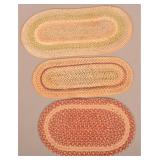 Three Oblong Multi-Colored Braided Table Mats.