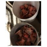 (2) Partial Buckets of Rebar Safety Caps