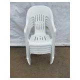 Stack of Five White Plastic Patio Chairs