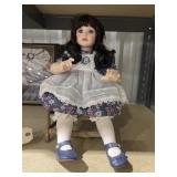 Porcelain Doll on Wooden Chair