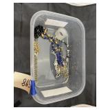 Plastic bin w/necklaces