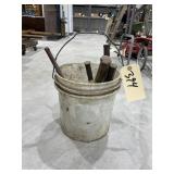 Bucket of Metal Spikes in Plastic Bucket