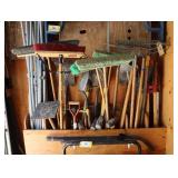 Lot of landscaping tools, rakes, shovels, picks,