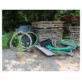 Lot of corrugated pipe, pump hose, poly tank,