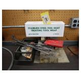 Stainless steel foil wrap, tongs, fire brick