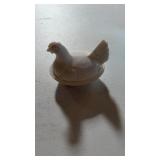 Small hen in nest