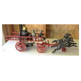 Vintage cast iron horse-drawn fire pumper toy