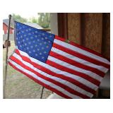 50-star United States flag on a silver pole.