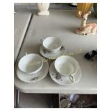 Three cups and saucers some roughness