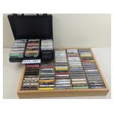 ASSORTED CASSETTES IN A CARRY CASE AND WALL ORGANI