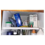 Contents of Bathroom Cabinet Shampoo Towels Hair