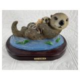 Plaster Otter Figurine on Wooden base.