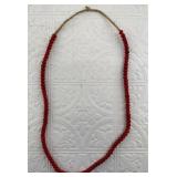 Strand of red whiteheart trade beads,