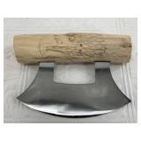 Alaskan Ulu knife with wood handle bearing a relie