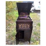 Silver tone phonograph with ornate front, body in