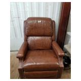 Brown leather recliner with brass accents, small s