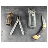 Buck 110 classic folder in sheath and a Leatherman