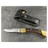 Classic Buck 110 V folder in correct leather sheat