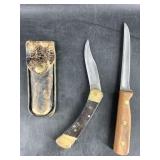 Lot with a Buck 110 Classic folder, in a well used