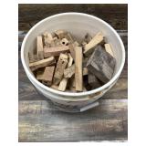 Large bucket full of pen blanks in variety of wood