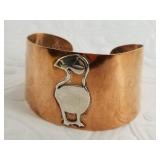 Hand crafted copper cuff bracelet, depicting a puf