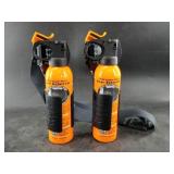 Two cans of bear spray both with belt clips, 1 has