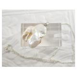 Large mother of pearl pendant on a short chain