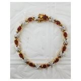 Beautiful new in box tennis bracelet with garnets