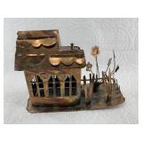 Stamped copper little cabin with a flower bed out