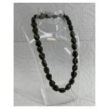 Strand of multi-shift green beads