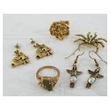 Several pieces of Alaskan jewelry with gold tone