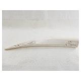 Scrimshaw of a bear stalking seals, in minimalist