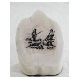 Primitive scrimshaw of a group of hunters on a sma