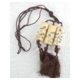 3 Bone carved pendants on a cord each as a contain