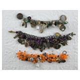 Several charm bracelets with several dozen charms
