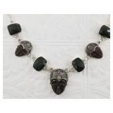 Sterling silver necklace with carved stone faces