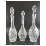 3 Crystal decanters with ornate stoppers
