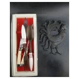 Serving ware utensils and a cast iron pot rest