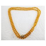 Long vintage fashion necklace with amber colored b