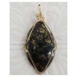 Gold toned wire wrap pendant with natural stone ce