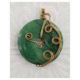 Jade pendant with a gold tone intricate wire wrapp