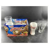 Assortment of vintage Coca Cola glasses and mugs