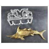 Aluminum coat hook and a brass ashtray