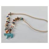 Necklace with many carved stone animals, the cente